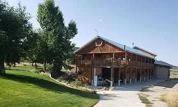 The front of the log home with its second-story glass solarium