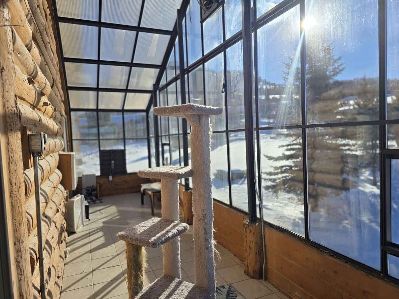 Inside one of the glass solariums in winter, looking out across snowy fields