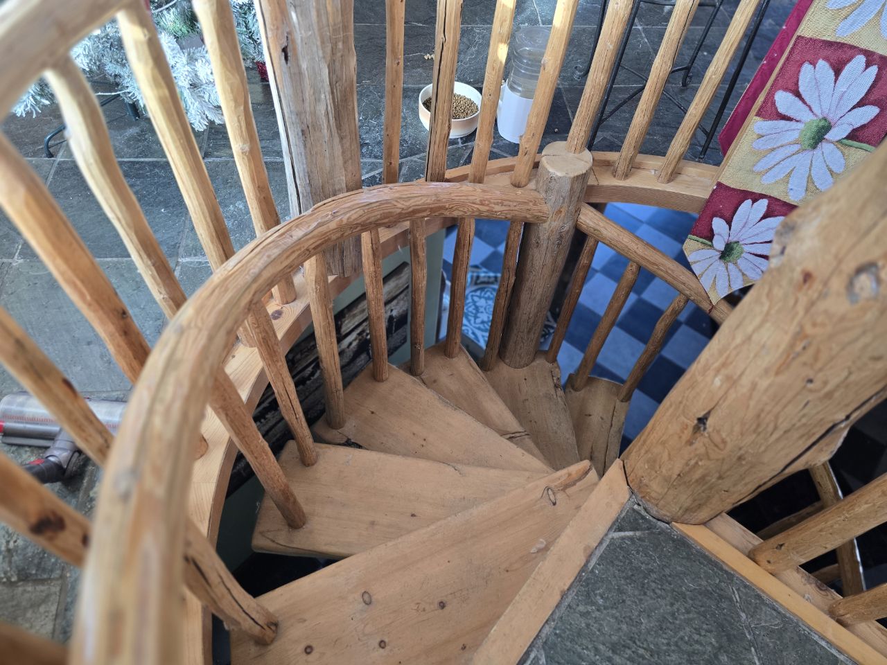 A hand-built spiral staircase made of natural log spindles